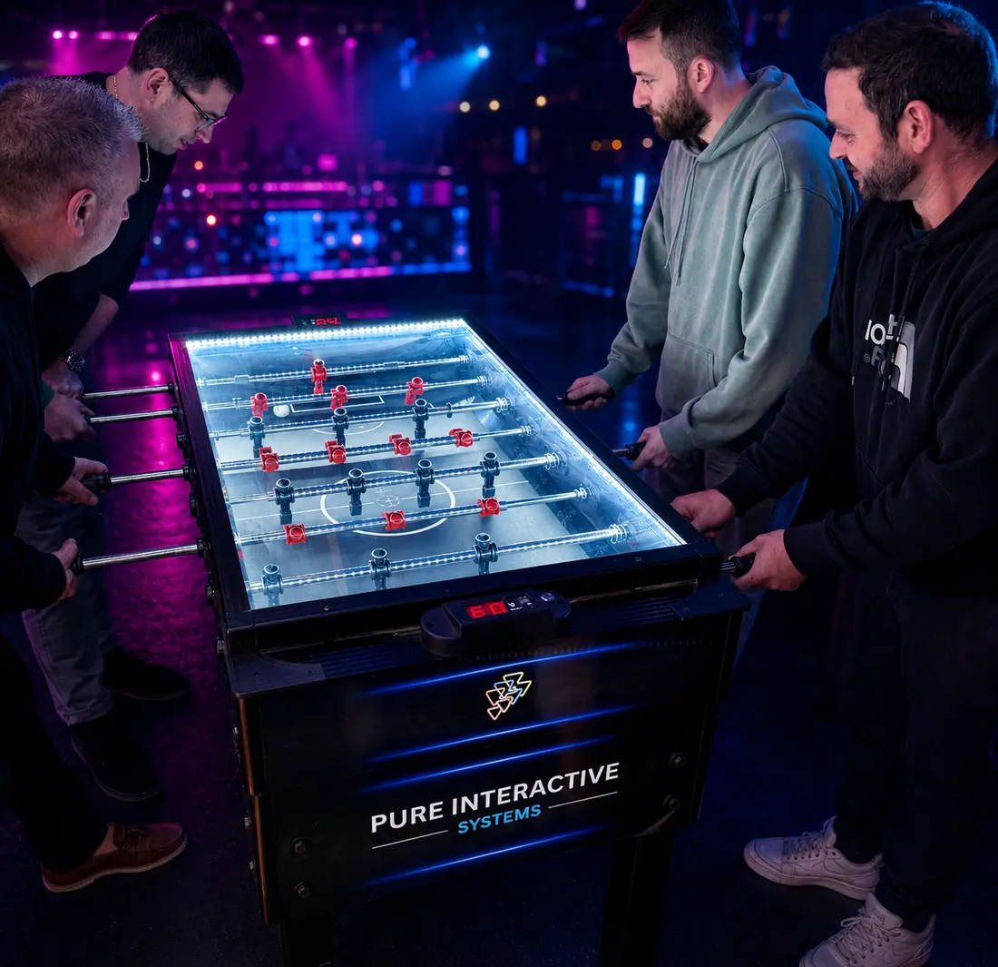 Four players around the Pure Interactive Systems football table
