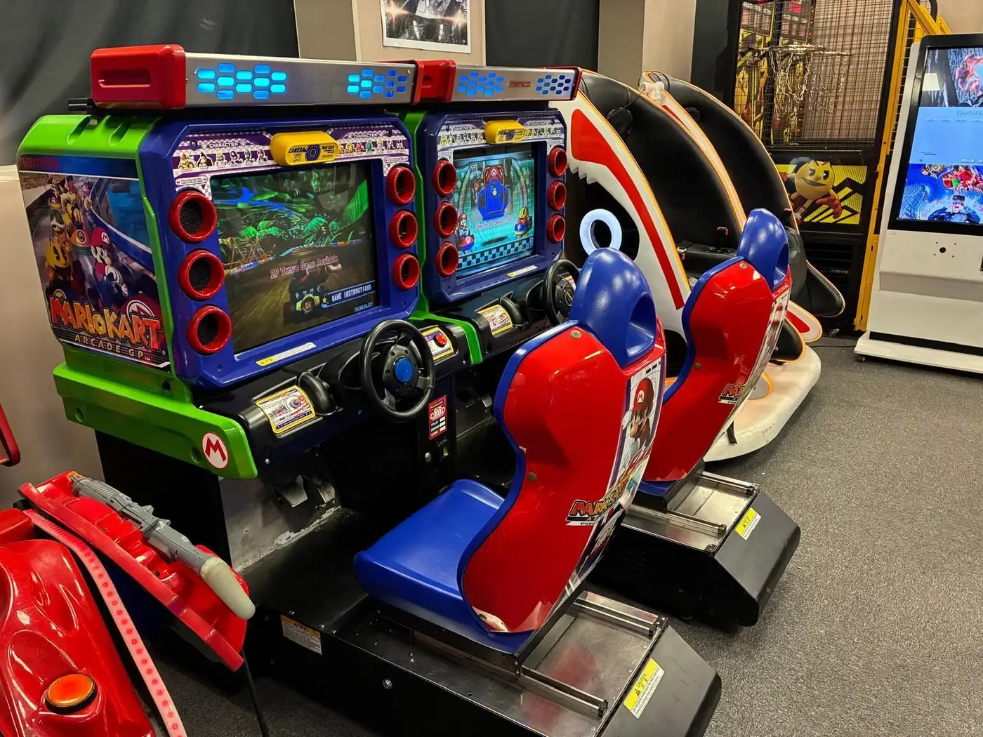 Mario Kart Arcade GP 2 twin-seat cabinet with Mario-branded bucket seats
