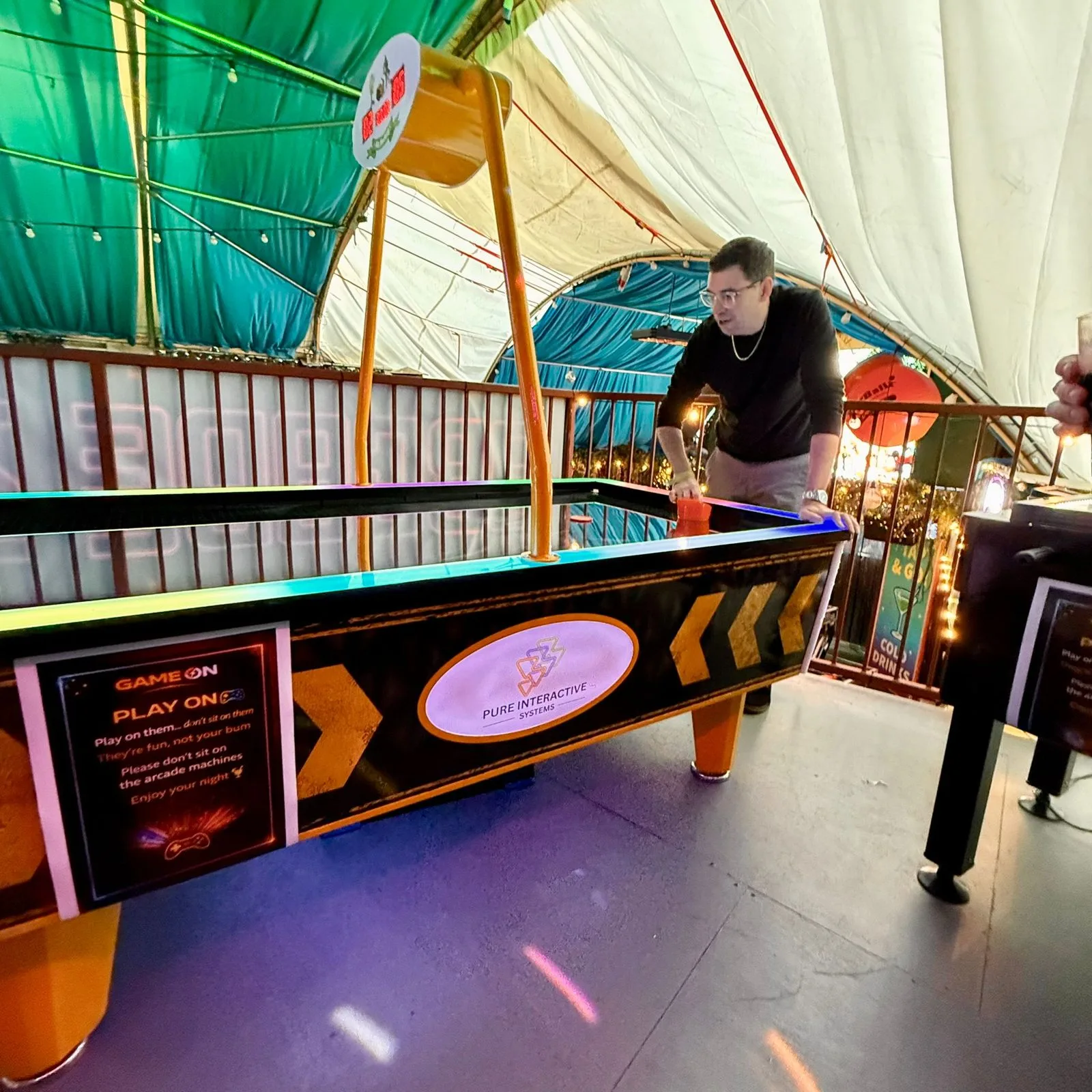 Players around the Power Glide air hockey table at Fire, Vauxhall