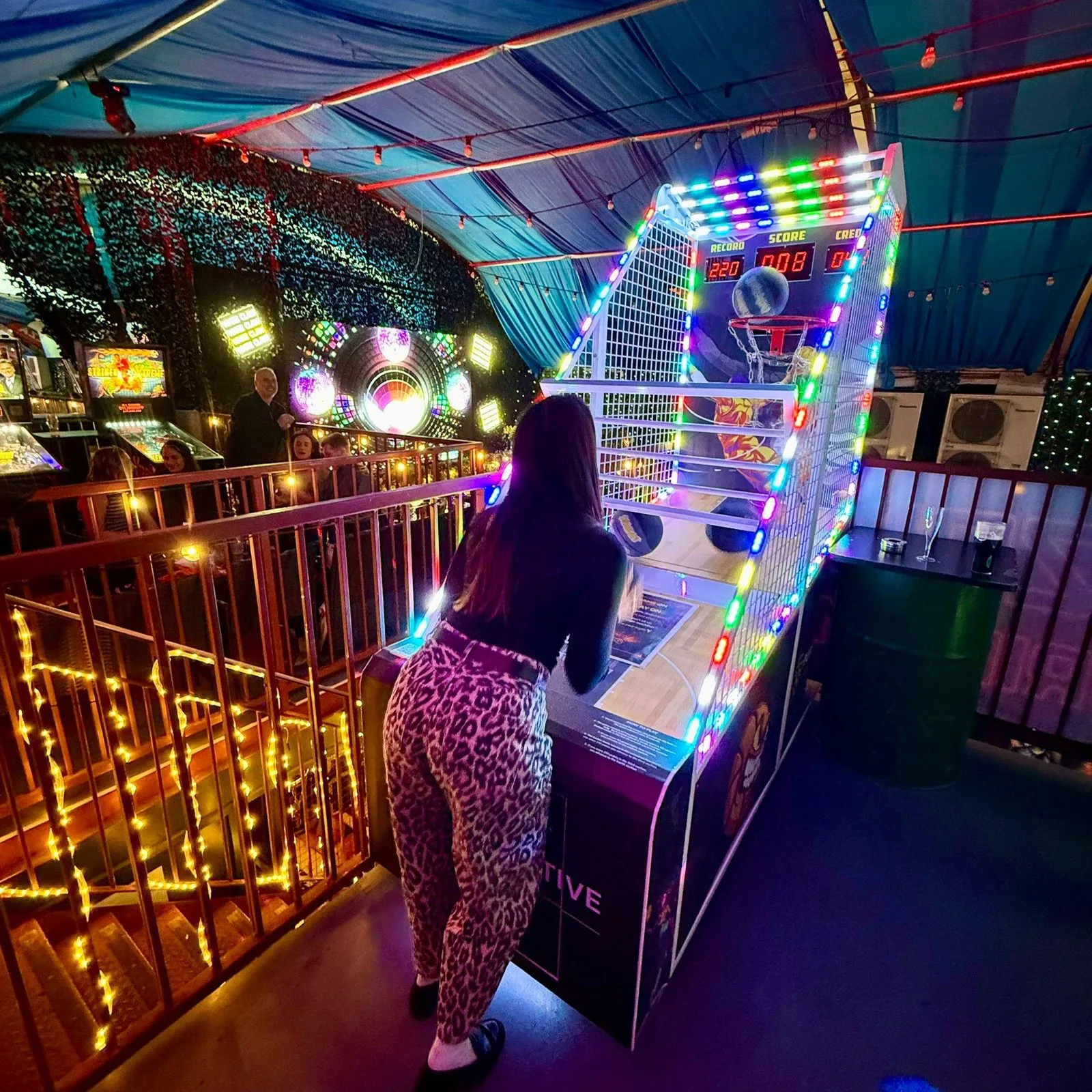 Player shooting on the Power Hoops basketball machine at Fire, Vauxhall