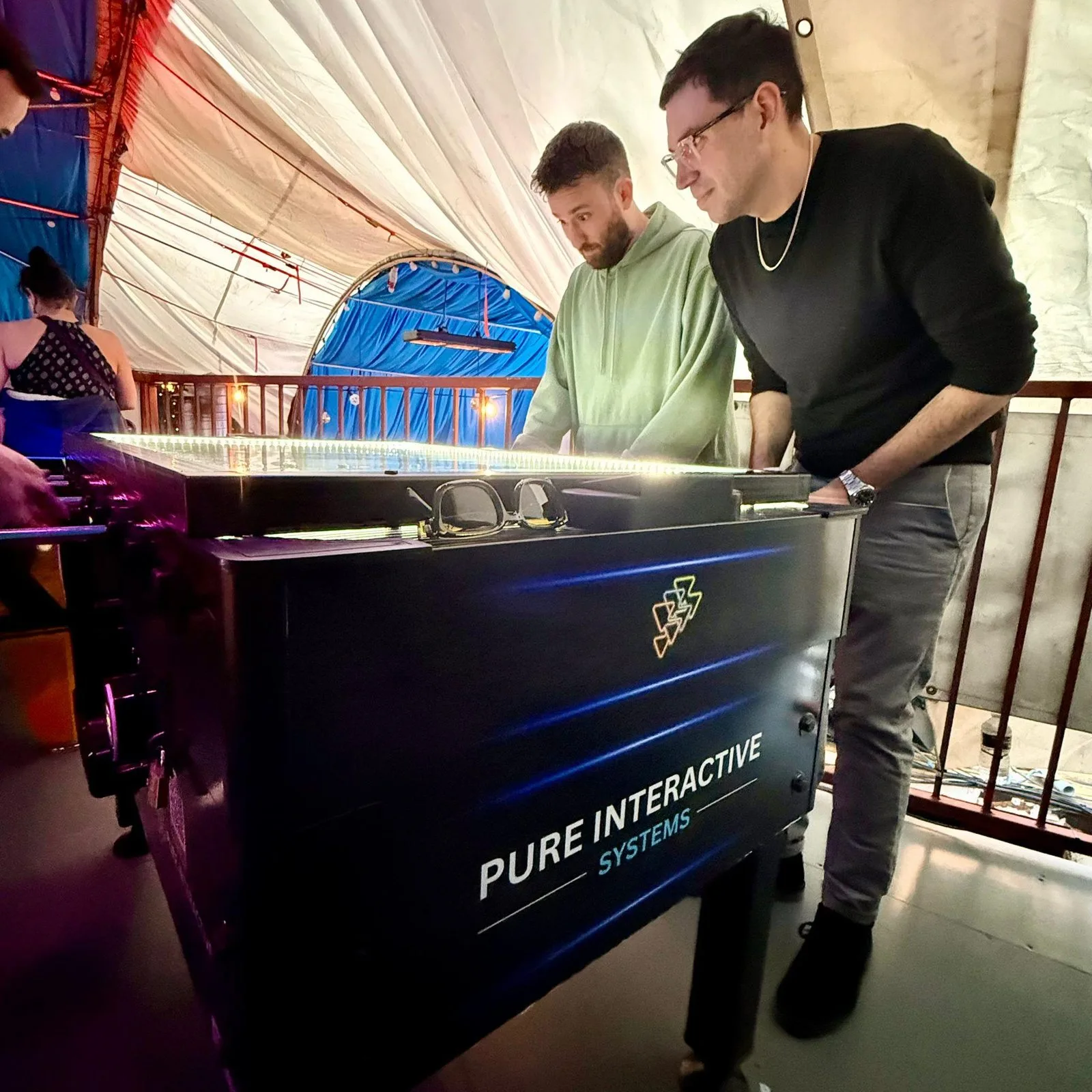 Two players on the Pure Interactive Systems football table at Fire London, Vauxhall