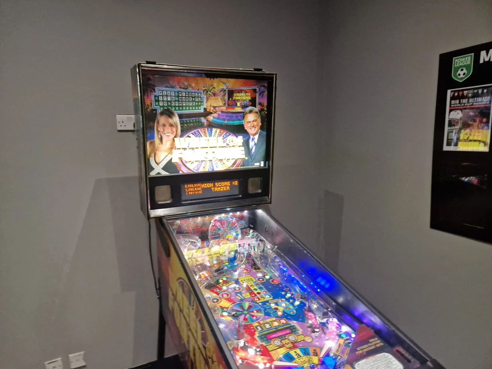 Stern Wheel of Fortune pinball machine, whole machine with lit playfield